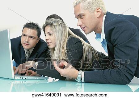 Business executives looking at a laptop View Large Photo Image Stock Image - Business executives looking at a laptop. Fotosearch