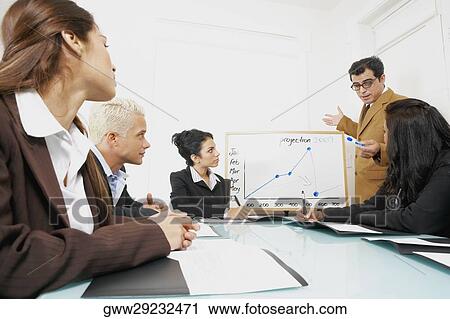 Businessman giving a presentation to business executives View Large Photo Image Stock Image - Businessman giving a presentation to business executives. Fotosearch