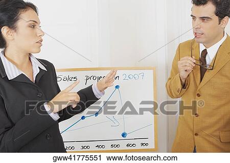 Businessman listening to a businesswoman View Large Photo Image Stock Image - Businessman listening to a businesswoman. Fotosearch