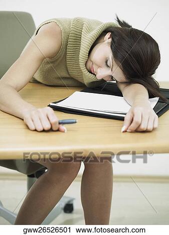 Businesswoman leaning on a desk View Large Photo Image Stock Image - Businesswoman leaning on a desk. Fotosearch