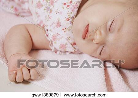 Stock Image - Close-up of a baby girl sleeping. Fotosearch