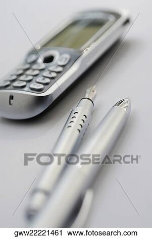 Close-up of a ballpoint pen and a fountain pen with a mobile phone View Large Photo Image Stock Image - Close-up of a ballpoint pen and a fountain pen with a mobile phone. Fotosearch