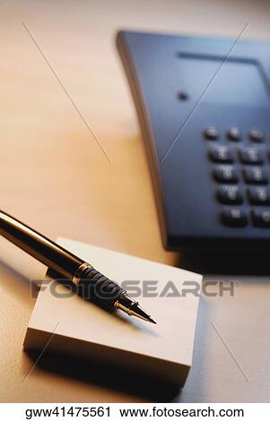 Close-up of a ballpoint pen on a adhesive notepad near the telephone View Large Photo Image Stock Image - Close-up of a ballpoint pen on a adhesive notepad near the telephone. Fotosearch