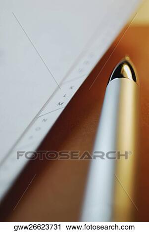 Stock Image - Close-up of a ballpoint pen with a diary. Fotosearch