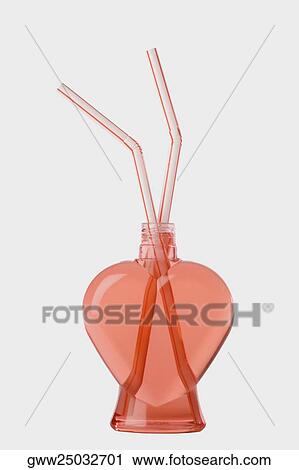 Close-up of a bottle of juice with two drinking straws View Large Photo Image Stock Image - Close-up of a bottle of juice with two drinking straws. Fotosearch