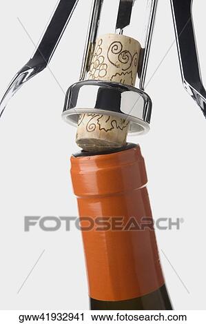 Stock Image - Close-up of a bottle with a corkscrew. Fotosearch