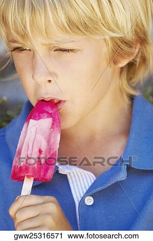 Close-up of a boy eating an ice-cream View Large Photo Image Stock Image - Close-up of a boy eating an ice-cream. Fotosearch