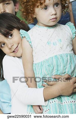 Close-up of a boy hugging his sister from behind View Large Photo Image Stock Image - Close-up of a boy hugging his sister from behind. Fotosearch