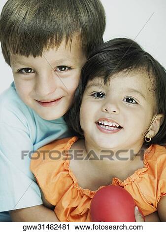 Close-up of a boy hugging his sister from behind View Large Photo Image Stock Image - Close-up of a boy hugging his sister from behind. Fotosearch