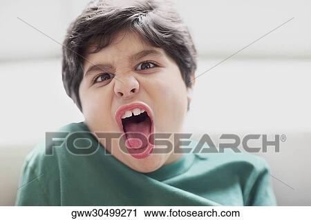 Close-up of a boy making a face View Large Photo Image Stock Image - Close-up of a boy making a face. Fotosearch