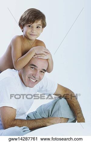 Close-up of a boy riding piggyback on his father View Large Photo Image Stock Image - Close-up of a boy riding piggyback on his father. Fotosearch