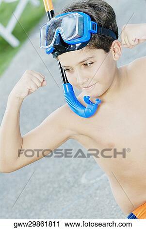 Close-up of a boy showing his muscles and wearing a snorkel View Large Photo Image Stock Image - Close-up of a boy showing his muscles and wearing a snorkel. Fotosearch