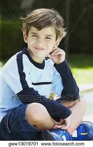 Stock Image - Close-up of a boy sitting. Fotosearch