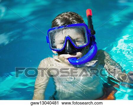 Stock Image - Close-up of a boy wearing a scuba mask in a swimming pool. Fotosearch