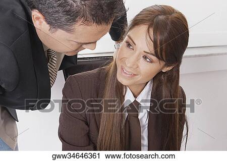Close-up of a businessman and a businesswoman talking View Large Photo Image Stock Image - Close-up of a businessman and a businesswoman talking. Fotosearch