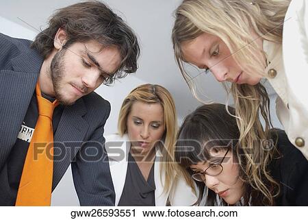 Close-up of a businessman and three businesswomen discussing View Large Photo Image Stock Image - Close-up of a businessman and three businesswomen discussing. Fotosearch