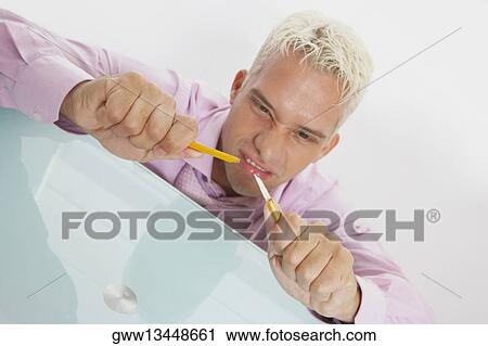 Stock Image - Close-up of a businessman breaking a pencil. Fotosearch