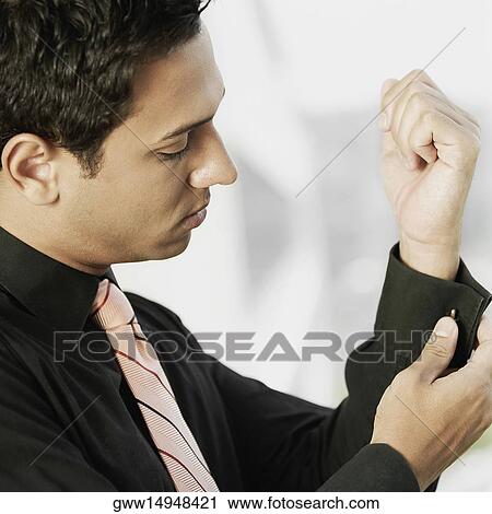 Close-up of a businessman buttoning his cuff View Large Photo Image Stock Image - Close-up of a businessman buttoning his cuff. Fotosearch