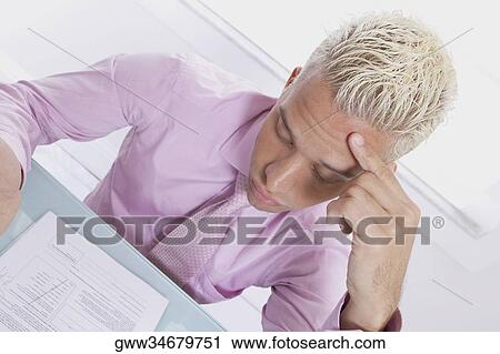 Close-up of a businessman reading a sheet of paper View Large Photo Image Stock Image - Close-up of a businessman reading a sheet of paper. Fotosearch