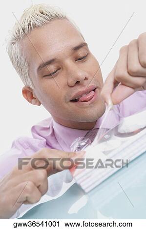Close-up of a businessman sticking his tongue out View Large Photo Image Stock Image - Close-up of a businessman sticking his tongue out. Fotosearch