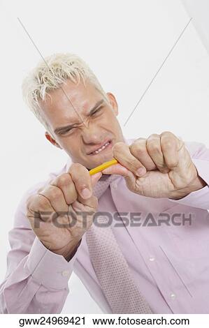 Close-up of a businessman trying to break a pencil View Large Photo Image Stock Image - Close-up of a businessman trying to break a pencil. Fotosearch