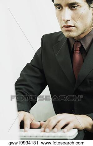 Stock Image - Close-up of a businessman working on a laptop. Fotosearch