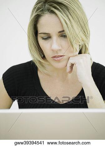 Stock Image - Close-up of a businesswoman using a laptop. Fotosearch