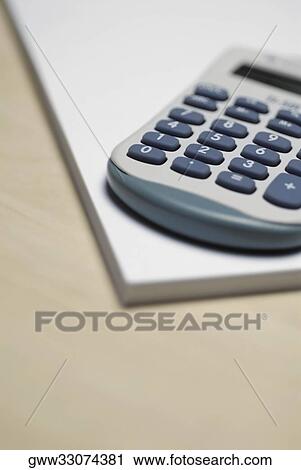 Close-up of a calculator on a notepad View Large Photo Image Stock Image - Close-up of a calculator on a notepad. Fotosearch