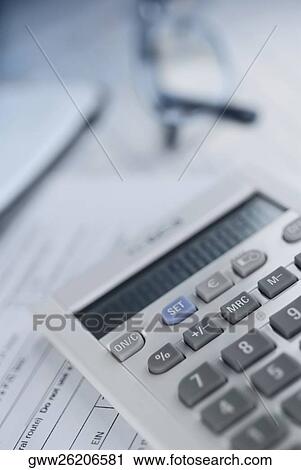 Close-up of a calculator with a pair of eyeglasses on documents View Large Photo Image Stock Image - Close-up of a calculator with a pair of eyeglasses on documents. Fotosearch