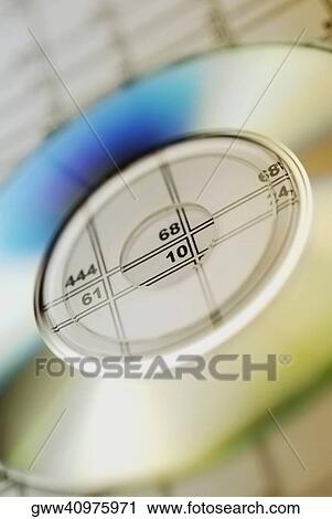Stock Image - Close-up of a CD on paper. Fotosearch