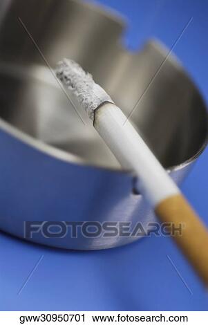 Stock Image - Close-up of a cigarette in an ashtray. Fotosearch