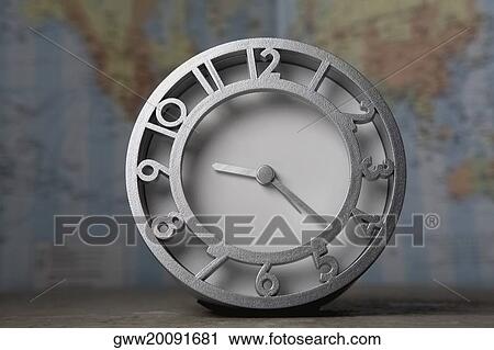 Close-up of a clock in front of a map View Large Photo Image Stock Image - Close-up of a clock in front of a map. Fotosearch