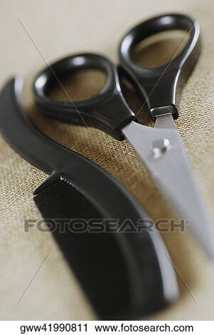 Close-up of a comb and a scissor View Large Photo Image Stock Image - Close-up of a comb and a scissor. Fotosearch