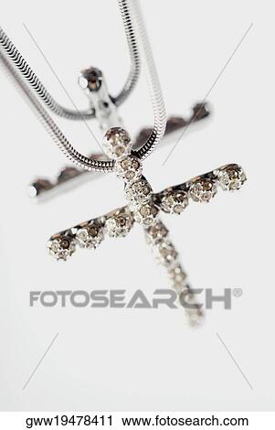 Close-up of a cross shaped pendant in a necklace View Large Photo Image Stock Image - Close-up of a cross shaped pendant in a necklace. Fotosearch