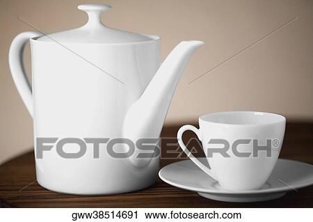 Close-up of a cup and a saucer with a tea kettle View Large Photo Image Stock Image - Close-up of a cup and a saucer with a tea kettle. Fotosearch