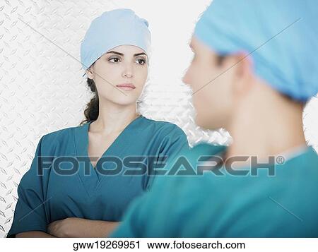 Close-up of a female doctor behind a male doctor View Large Photo Image Stock Image - Close-up of a female doctor behind a male doctor. Fotosearch