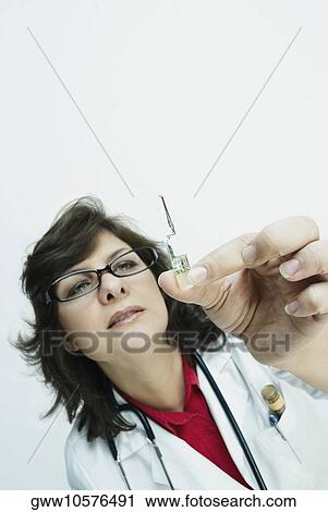 Close-up of a female doctor holding a vial View Large Photo Image Stock Image - Close-up of a female doctor holding a vial. Fotosearch