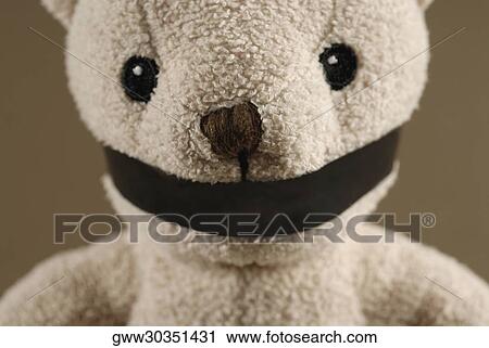 Close-up of a gagged teddy bear View Large Photo Image Stock Image - Close-up of a gagged teddy bear. Fotosearch