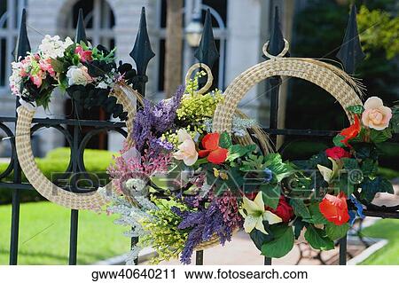 Close-up of a gate decorated with flowers View Large Photo Image Stock Image - Close-up of a gate decorated with flowers. Fotosearch