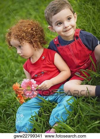 Close-up of a girl and her brother sitting together View Large Photo Image Stock Image - Close-up of a girl and her brother sitting together. Fotosearch