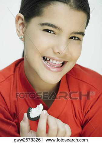 Close-up of a girl holding a cookie View Large Photo Image Stock Image - Close-up of a girl holding a cookie. Fotosearch