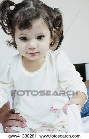 Close-up of a girl holding a towel View Large Photo Image Stock Image - Close-up of a girl holding a towel. Fotosearch