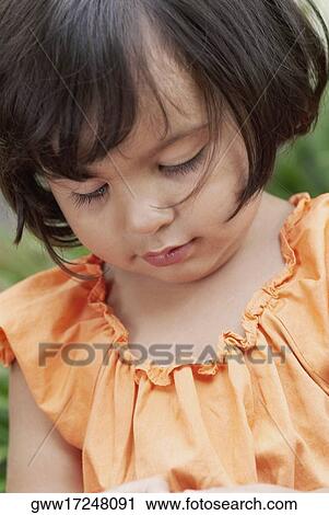 Stock Image - Close-up of a girl looking down. Fotosearch