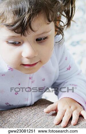 Close-up of a girl looking down View Large Photo Image Stock Image - Close-up of a girl looking down. Fotosearch