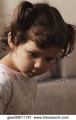 Close-up of a girl looking down View Large Photo Image Stock Image - Close-up of a girl looking down. Fotosearch