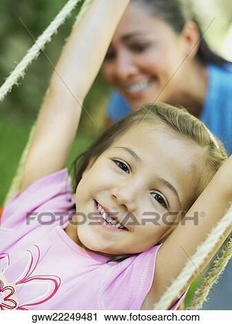 Close-up of a girl on a swing View Large Photo Image Stock Image - Close-up of a girl on a swing. Fotosearch