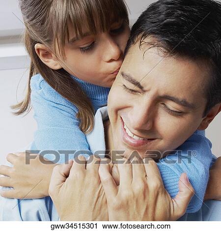 Stock Image - Close-up of a girl riding piggyback on her father. Fotosearch