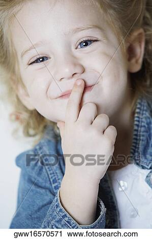 Close-up of a girl smirking View Large Photo Image Stock Image - Close-up of a girl smirking. Fotosearch