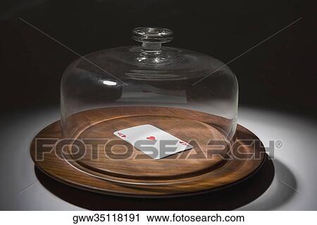 Close-up of a glass container covering a playing card on a dish View Large Photo Image Stock Image - Close-up of a glass container covering a playing card on a dish. Fotosearch