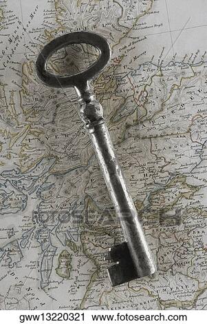 Stock Image - Close-up of a key on a map. Fotosearch